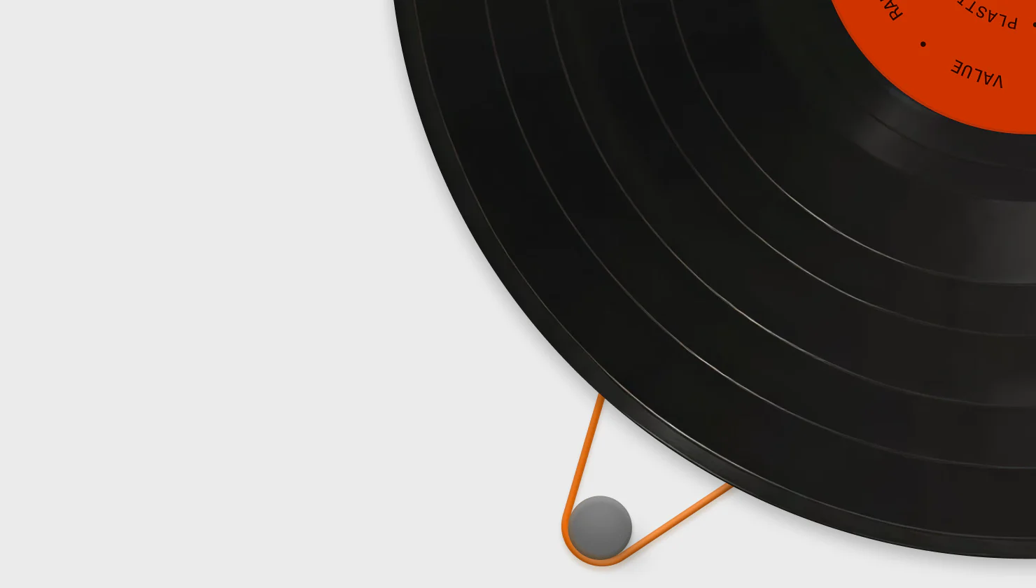 Vinyl record with an orange value label beside a stylus
